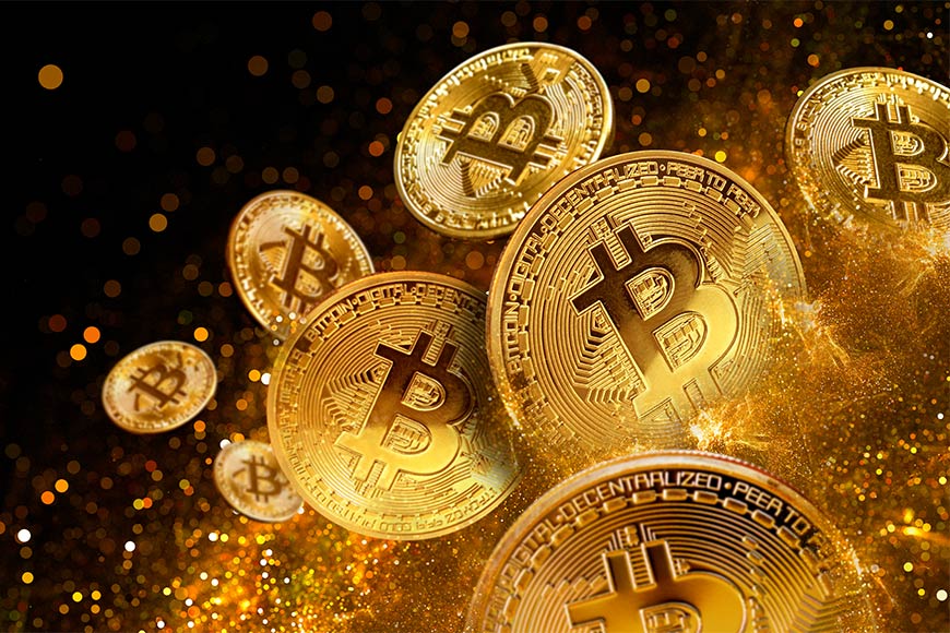 Illustration of shiny gold Bitcoins with sparklies